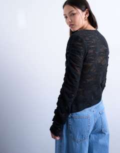 Model wearing Lace asymmetric top in black