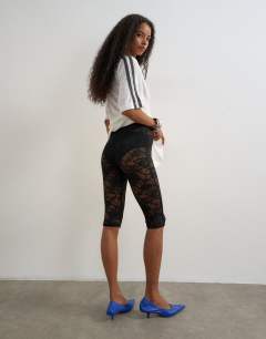 Model wearing Lace capri legging hosiery in black