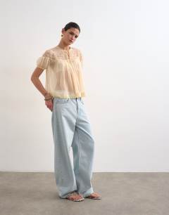 Model wearing Lace detail short sleeve top with tie in ivory