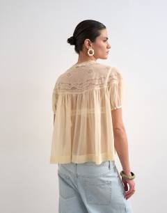 Model wearing Lace detail short sleeve top with tie in ivory