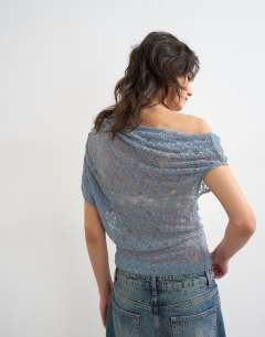 Model wearing Lace fallen shoulder top in blue