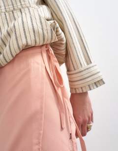 Model wearing Lace hem wrap mini skirt in pink