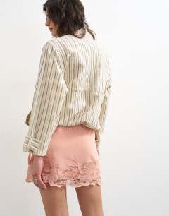 Model wearing Lace hem wrap mini skirt in pink