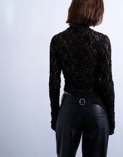 Model wearing Lace high neck long sleeve asymmetric hem top in black