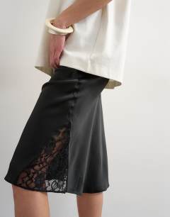Model wearing Lace Insert awkward length midi skirt in black