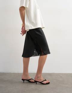 Model wearing Lace Insert awkward length midi skirt in black