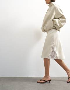 Model wearing Lace Insert awkward length midi skirt in ivory