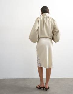 Model wearing Lace Insert awkward length midi skirt in ivory