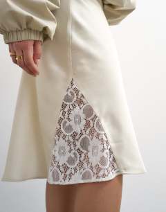 Model wearing Lace Insert awkward length midi skirt in ivory