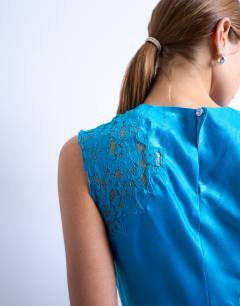 Model wearing Lace insert grown on shoulder top in deep bue