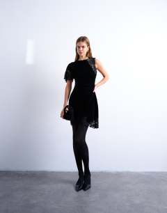 Model wearing Lace insert grown on shoulder velvet mini dress in black