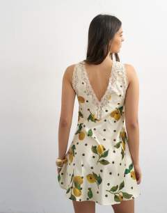Model wearing Lace insert pintucked waist mini tea dress in Lemon Polka Dot