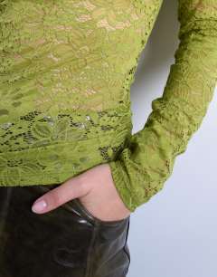Model wearing Lace ruched side long sleeve top in green