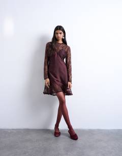 Model wearing Lace sleeve flippy hem mini dress in port royale