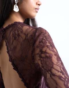 Model wearing Lace sleeve flippy hem mini dress in port royale