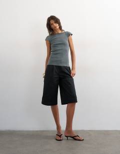 Model wearing Lace trim cap sleeve top in washed black