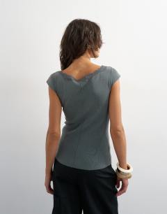 Model wearing Lace trim cap sleeve top in washed black