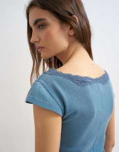 Model wearing Lace trim cap sleeve top in washed navy