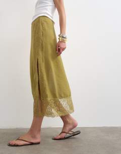Model wearing Lace trim maxi skirt in olive green