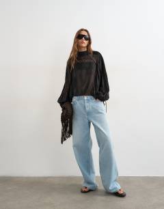 Model wearing Lace trim ruched side blouse in black