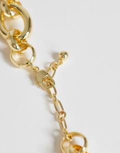 Model wearing Lana oversized chain necklace with charms in gold tone