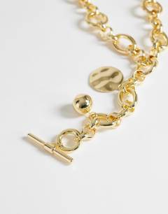 Model wearing Lana oversized chain necklace with charms in gold tone