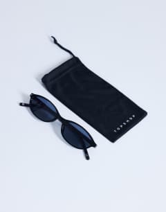 Model wearing Lanzarote oval sunglasses in black