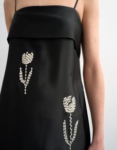 Model wearing Lapel bust maxi dress with embroidered flowers in black