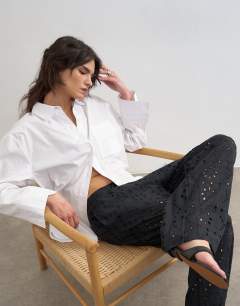 Model wearing Large broderie cut out tie waist trouser in black
