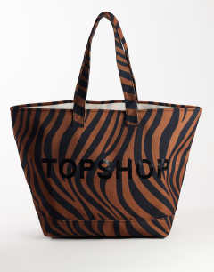 Model wearing Large canvas tote bag in chocolate zebra