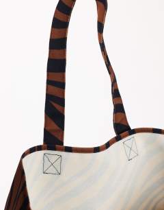 Model wearing Large canvas tote bag in chocolate zebra