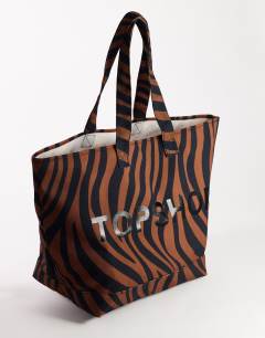 Model wearing Large canvas tote bag in chocolate zebra