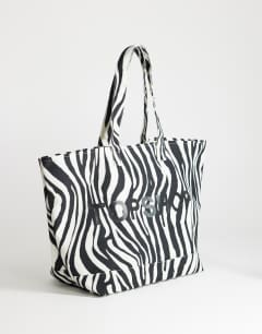 Model wearing Large canvas tote bag in zebra print