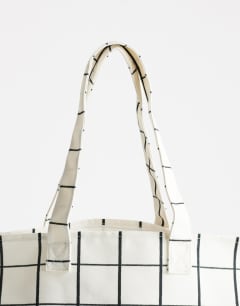 Model wearing Large printed canvas tote bag in check