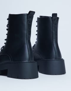 Model wearing Lawrence chunky lace up boots in black