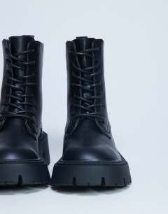 Model wearing Lawrence chunky lace up boots in black