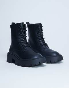 Model wearing Lawrence chunky lace up boots in black