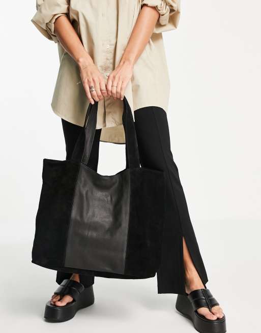 Black leather shop and suede handbag