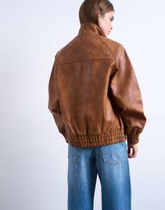 Model wearing Leather look funnel neck jacket in washed brown