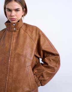 Model wearing Leather look funnel neck jacket in washed brown
