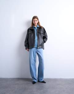 Model wearing Leather look oversized funnel neck zip through jacket in black