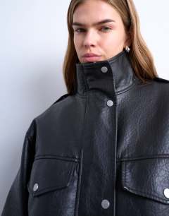 Model wearing Leather look oversized funnel neck zip through jacket in black