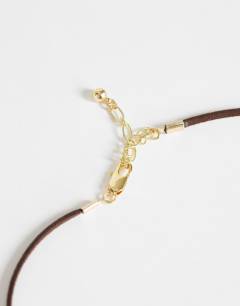 Model wearing Leila cord necklace with pendant in gold and brown