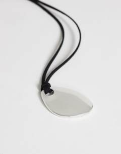 Model wearing Leila cord necklace with pendant in silver and black