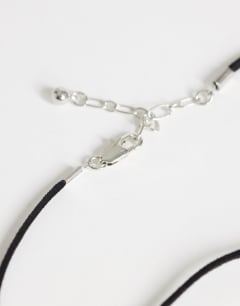 Model wearing Leila cord necklace with pendant in silver and black