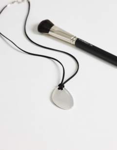 Model wearing Leila cord necklace with pendant in silver and black