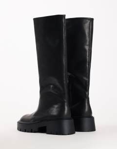 Model wearing Lennox chunky knee high boot in black