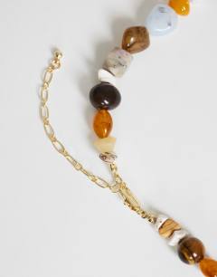 Model wearing Leo semi precious beaded necklace in pearl multi