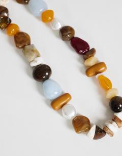 Model wearing Leo semi precious beaded necklace in pearl multi