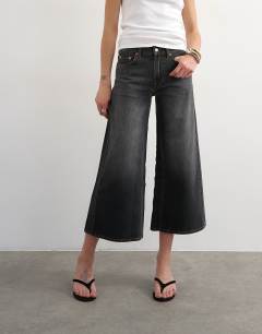 Model wearing Light weight wide crop jean in washed black